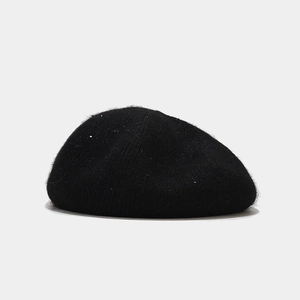 Close-up of black sequined beret hat showing wool blend texture and sparkling details