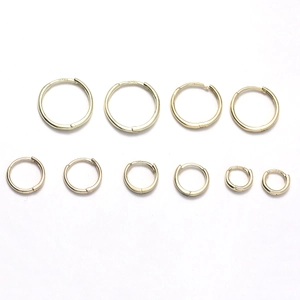 Set of 925 sterling silver gold plated hoop earrings in various sizes on white background