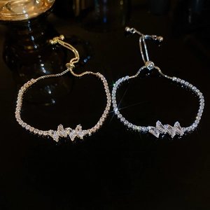 Macro shot of gold and silver adjustable zircon butterfly pull-out tennis bracelets