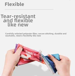 Close-up of flexible baby cloth book being pulled to show tear-resistant polyester fabric