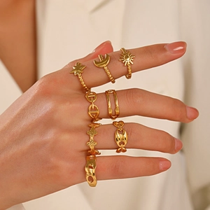 Set of 8 gold stainless steel adjustable rings with celestial sun moon and star designs
