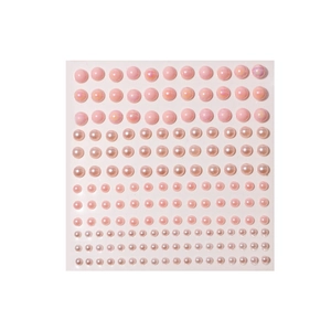 Detailed view of pink pearl adhesive stickers in various sizes for hair and nail art