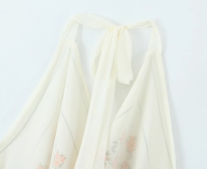 Detail of floral printed satin halter top with neck tie and chiffon fabric texture