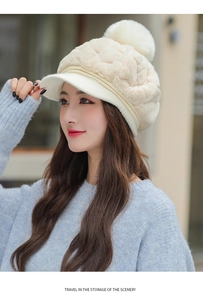 Detailed view of women's plush knit cap with pom-pom and brim in elegant cream white