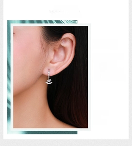 Macro shot of silver rocking horse hoop earring with micro-paved cubic zirconia stones