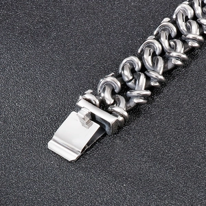 Macro view of silver stainless steel Byzantine woven chain bracelet with folding clasp