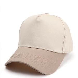 Detail of two-tone beige baseball cap showing curved brim and 5-panel twill fabric