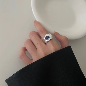 Irregular textured S925 silver ring with oval blue gemstone in a minimalist style