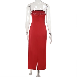 Detail view of red strapless satin dress featuring back invisible zipper and hem slit