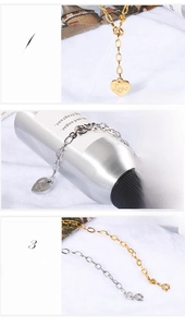 Detail of titanium steel heart pendant necklace with Love engraving and polished finish