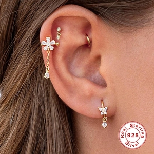 Detailed view of 925 sterling silver ear cuff set with flower and chain tassel in gold finish