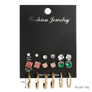 Detail view of 9-pair earring set with pearls and gems on a card showing sizes and weight