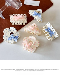 Detail of assorted acetate claw clips with floral patterns and silk ribbon bows