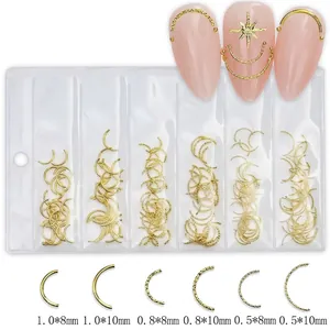 Detailed view of six sizes of gold curved metal nail art studs and bars in a clear packet