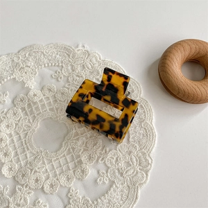 Macro shot of a square acetate hair claw clip with a classic leopard tortoiseshell pattern