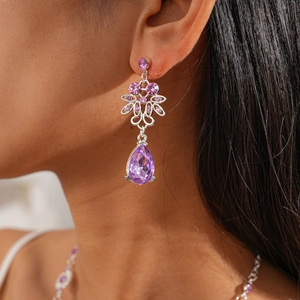 Exquisite drop earrings with purple zircon in floral hollowed silver setting worn by model