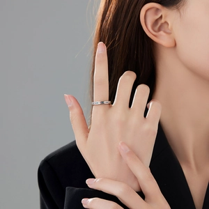 Elegant silver eternity ring with colorful cubic zirconia worn by model in soft light