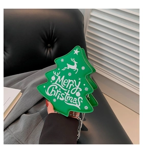Close-up of green Christmas tree shaped crossbody bag with silver chain and holiday motifs
