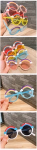Detail of round children's sunglasses featuring cute 3D rainbow and cloud ornaments