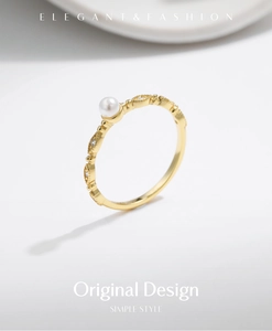 Detailed macro view of an elegant S925 silver gold ring with white pearl and small diamonds