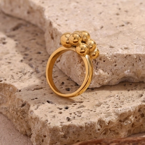 Minimalist 18K gold plated bubble ring with cluster sphere design on stone stand