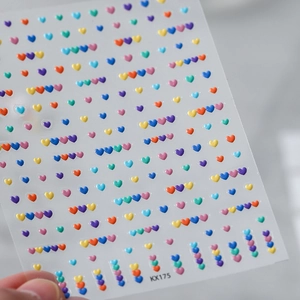 Macro detail of 3D embossed colorful heart nail art stickers showing model KX175