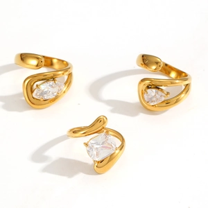 Three gold zirconia stackable rings with marquise, pear, and square cut stones
