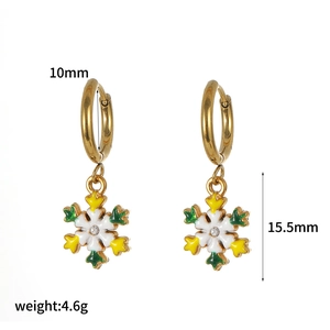 Detailed view of gold snowflake earrings with enamel accents and 15.5mm size dimensions