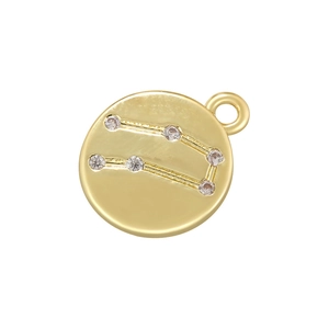 Macro shot of gold-plated Gemini zodiac pendant with shimmering zircon constellation