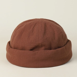 Close-up of brown cotton docker cap showing natural fabric texture and stitching details