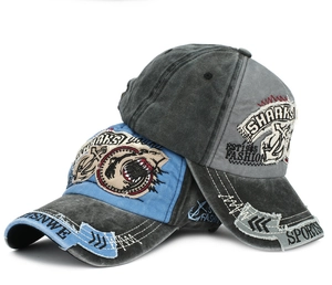 Detail of shark embroidery and distressed washed cotton on a 3D letter baseball cap