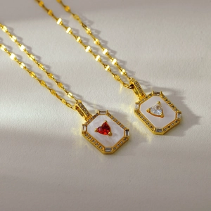 French vintage gold necklace with heart gemstone pendant on mother of pearl base