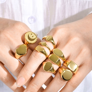 Set of gold stainless steel signet rings with heart, moon, star, and rose engravings