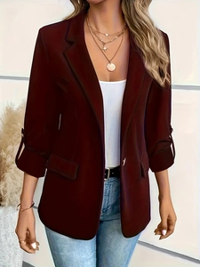 Detailed shot of burgundy women blazer featuring lapel collar and single button closure