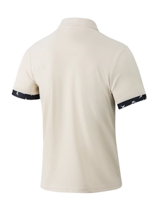 Rear view detail of beige waffle knit polo shirt with bird pattern trims on short sleeves