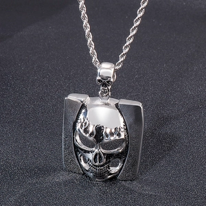 Detailed macro view of vintage skull pendant in silver titanium steel with textured chain