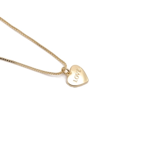 Golden heart necklace with MOM and LOVE engraving on white background for Mothers Day
