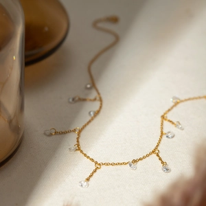 Detail of 18k gold stainless steel necklace with sparkling teardrop zircon pendants