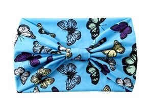 Detail of blue yoga headband featuring colorful butterfly patterns and center knot design