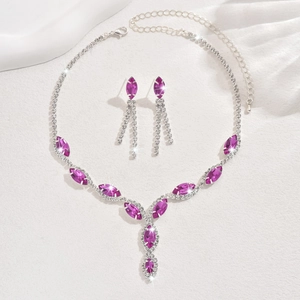 Macro detail of bridal jewelry set with purple marquise gemstones and silver fringe