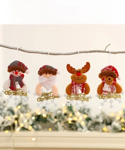 Close-up of plush Christmas ornaments with Santa, snowman, and reindeer on a branch