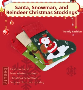 Close-up of linen Christmas stockings with Santa, reindeer and snowman embroidery details