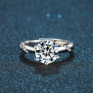 Detailed macro view of silver ring with six-prong moissanite setting and side diamonds