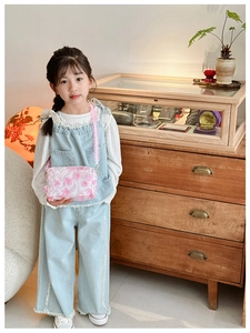 Detail of child floral crossbody bag with 3D pink cherry blossom appliqués and lace strap