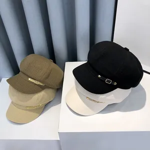 Detail of waffle textured newsboy caps in black, white, khaki and camel colors