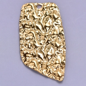 Detail shot of a golden irregular crumpled metal heart pendant with hammered texture