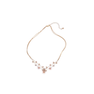 Three-layer rose gold necklace with resin flower pendant and pearl accents on white background