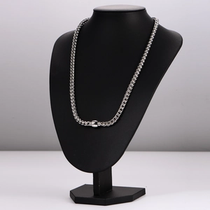 Minimalist silver stainless steel braided dragon chain necklace on black mannequin display