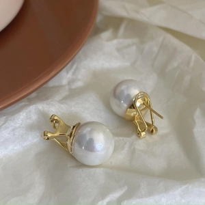 Close-up of S925 silver pearl earring with gold finish and lustrous white pearl