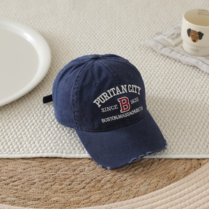 Detailed shot of distressed navy cotton baseball cap with vintage Boston embroidery
